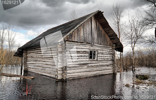 Image of old rural house in water