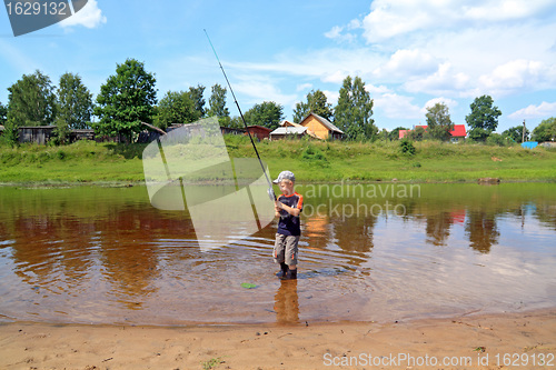 Image of boy fishes on coast river