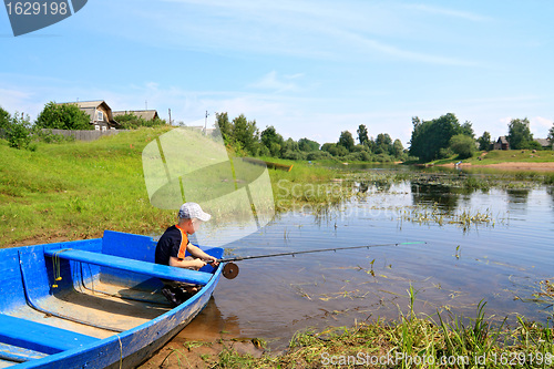 Image of boy fishes on coast river