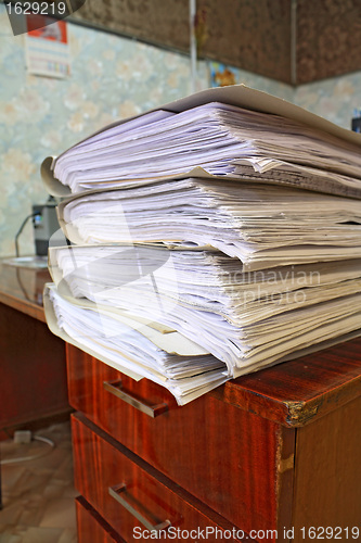 Image of heap of the papers on table in office