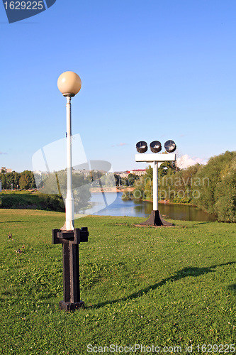 Image of row of the torches on green glade 