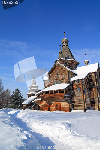 Image of wooden chapel on snow field 