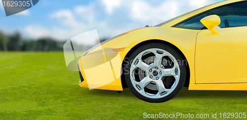 Image of Yellow Luxury Sport Car outdoor on green grass