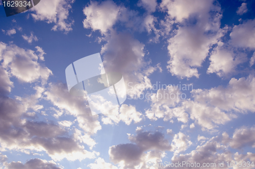 Image of cloudy blue spring sky sun-lit background 