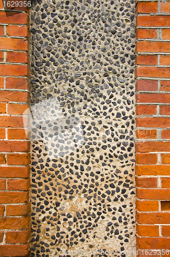 Image of Wall made of brick and concrete with little stones