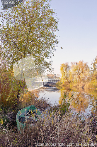 Image of Wooden boat locked near river. Autumn morning view 