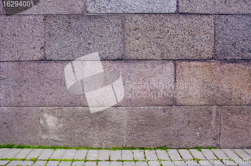 Image of Block wall and tiled path fragments background.