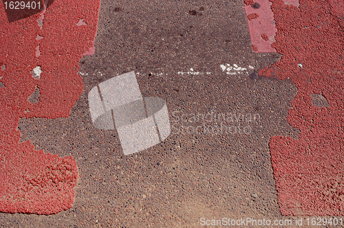 Image of Asphalt road with red pointed pedestrian crossway. 