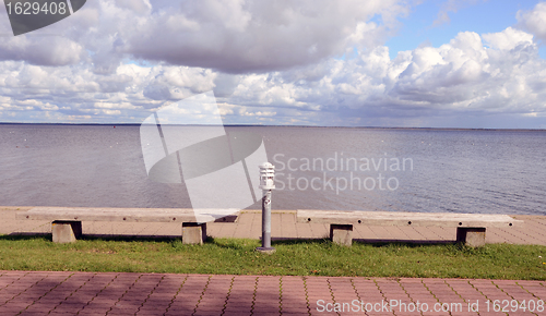 Image of Benches and lighting in front of the lake . 