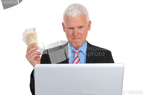 Image of Businessman with Bills and Laptop on Sofa