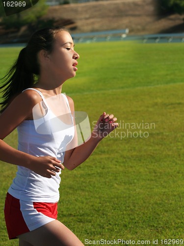 Image of Teen girl running on the stadium