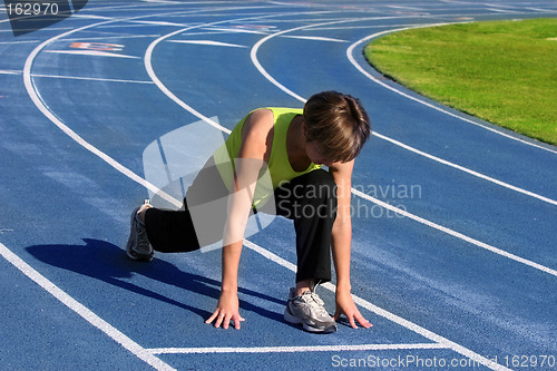 Image of Woman exercising on a blue racetrack