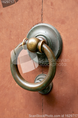 Image of Metal door knocker on wooden door