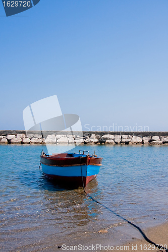 Image of Small fishing boat floating on the water 