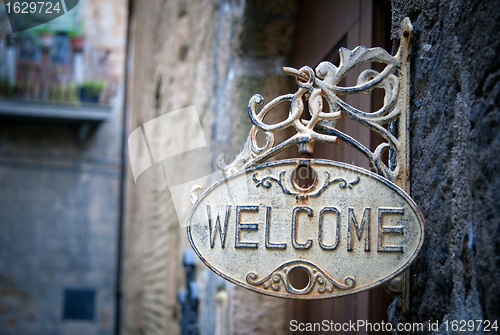 Image of Welcome sign on log home