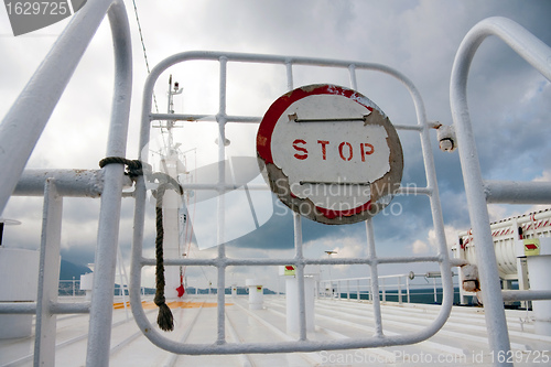 Image of Sign Stop on a gate on boat