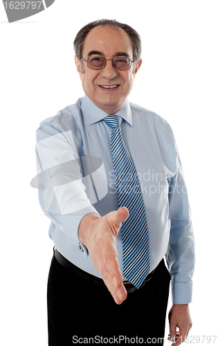 Image of Confident modern businessman offering handshake