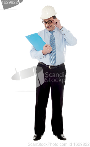 Image of Elder architect studying file