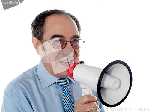 Image of Elderly businessman making an announcement