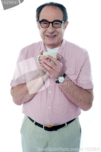 Image of Old man holding a coffee mug