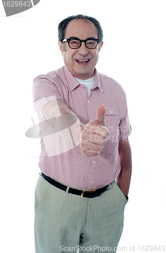 Image of Smiling aged male gesturing thumbs-up