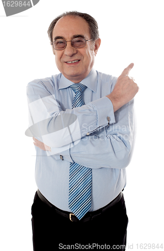 Image of Senior businessperson pointing away