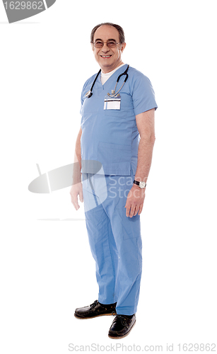 Image of Aged doctor posing with stethoscope around his neck