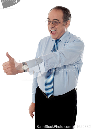 Image of Successful entrepreneur gesturing thumbs-up