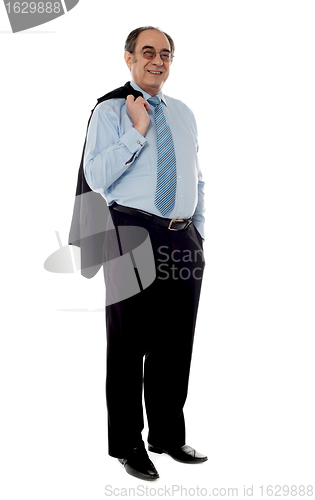 Image of Senior businessman holding coat over his shoulders