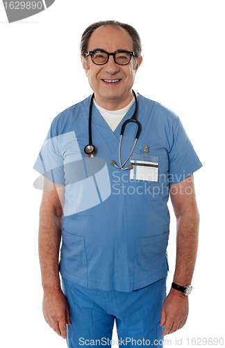 Image of Handsome smiling senior doctor posing in front of camera