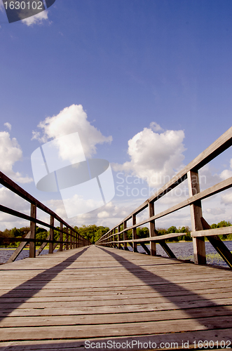 Image of long walk wooden sirvenos lake bridge in astravas 