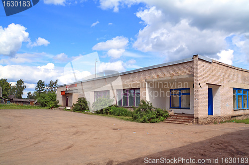 Image of gray brick building on rural street
