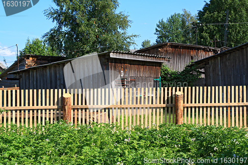 Image of new wooden fence in rural vegetable garden