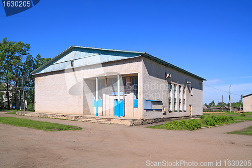 Image of gray brick building on rural street