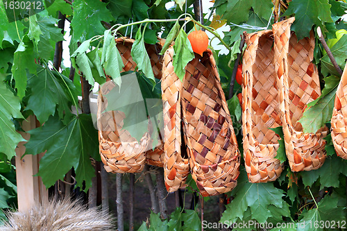 Image of wooden footwear amongst green sheet