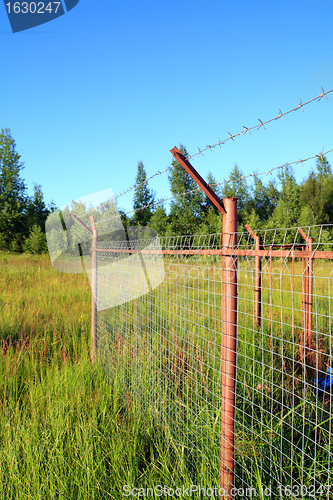 Image of fence on green field