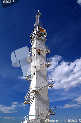 Image of white lighthouse on cloudy background