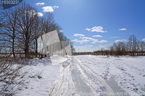 Image of icy road on coast river