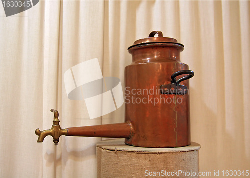 Image of ancient copper teapot on stand