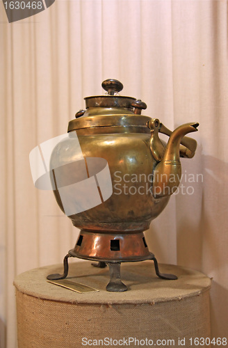 Image of ancient copper teapot on stand