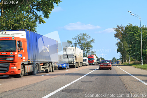 Image of cargo cars on asphalt road