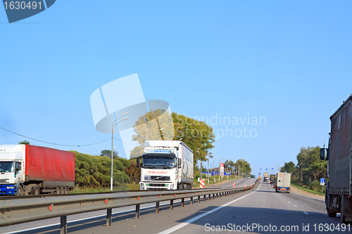 Image of cargo cars on asphalt road