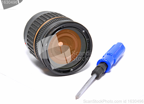 Image of lens and screwdriver on white background