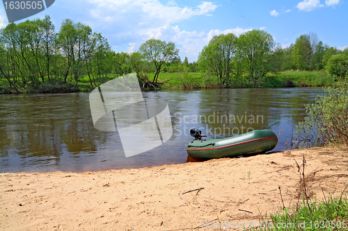 Image of motor boat on river coast