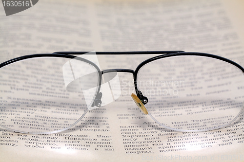 Image of spectacles on old book