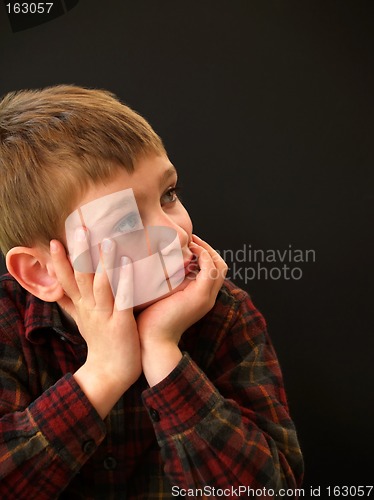 Image of boy resting face in hands