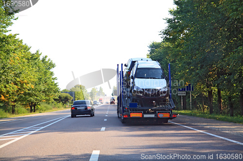 Image of cargo cars on asphalt road