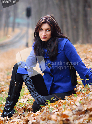Image of Young woman in the autumn park