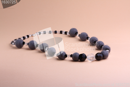 Image of Grey necklace at pink background