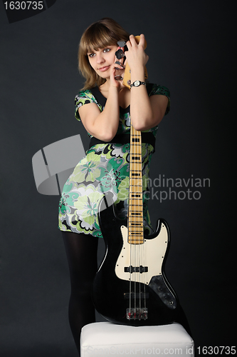 Image of Young beautiful girl with a guitar